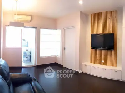 Modern living room with sleek TV setup and natural light