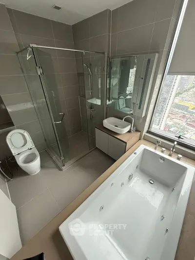 Luxurious modern bathroom with city view, featuring a spacious bathtub and sleek glass shower.