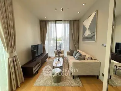Modern living room with elegant decor and large windows offering natural light.