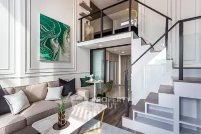 Luxurious modern loft with elegant staircase and stylish decor in bright living room.
