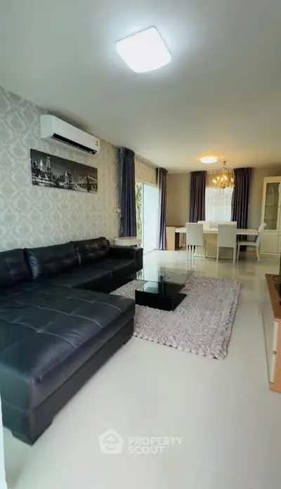 Spacious living room with modern decor and elegant dining area
