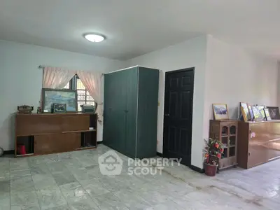 Spacious living area with elegant marble flooring and stylish wooden furniture.