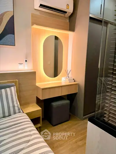 Modern bedroom with stylish vanity and ambient lighting, featuring sleek design and cozy atmosphere.