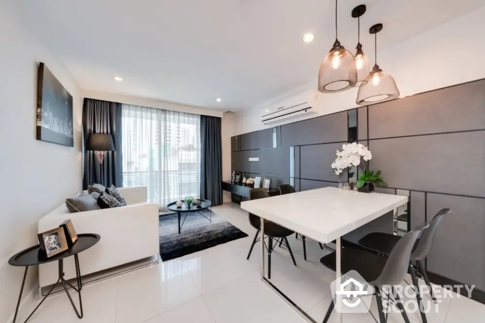 Modern living room with stylish decor and dining area in open layout apartment.