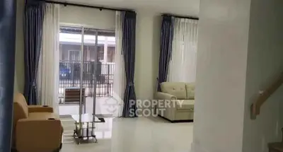 Spacious living room with modern furniture and large windows for natural light.
