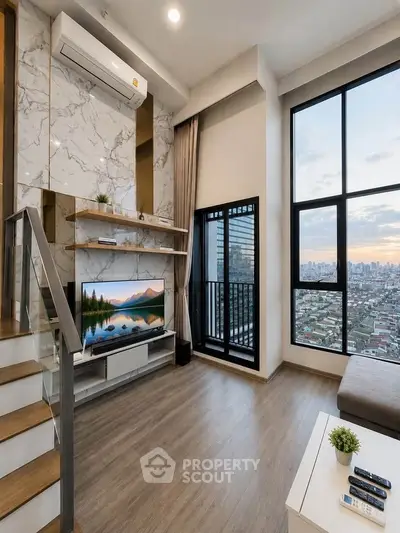Modern living room with large windows and city view, featuring stylish decor and a cozy atmosphere.
