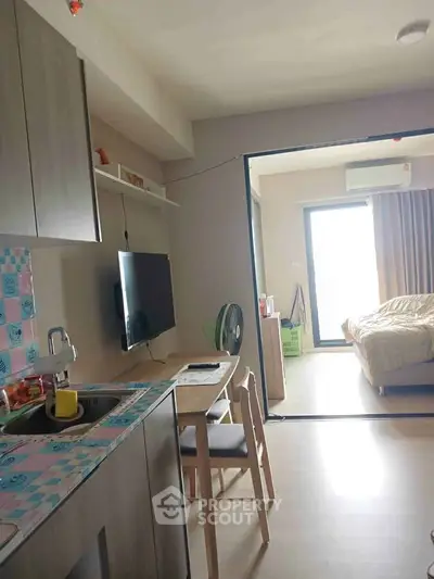 Modern studio apartment with open kitchen and cozy bedroom
