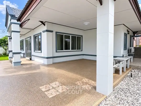 Charming single-story home with spacious patio and modern exterior design.
