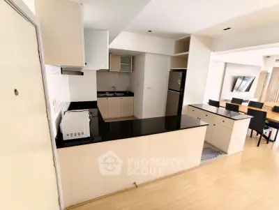 Spacious open-layout kitchen and dining area with modern appliances and sleek design.