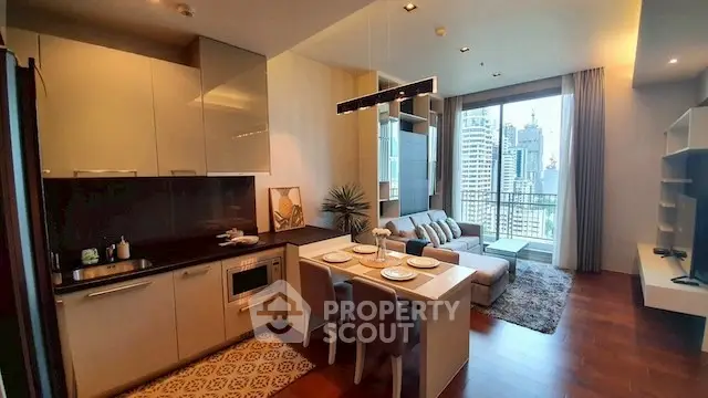 Modern open-layout kitchen and living room with city view balcony