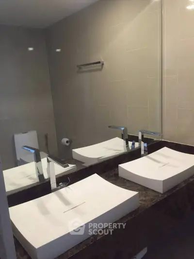 Modern bathroom with dual sinks and sleek fixtures