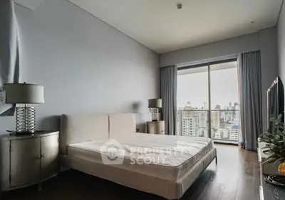 Spacious bedroom with city view and modern furnishings in luxury apartment