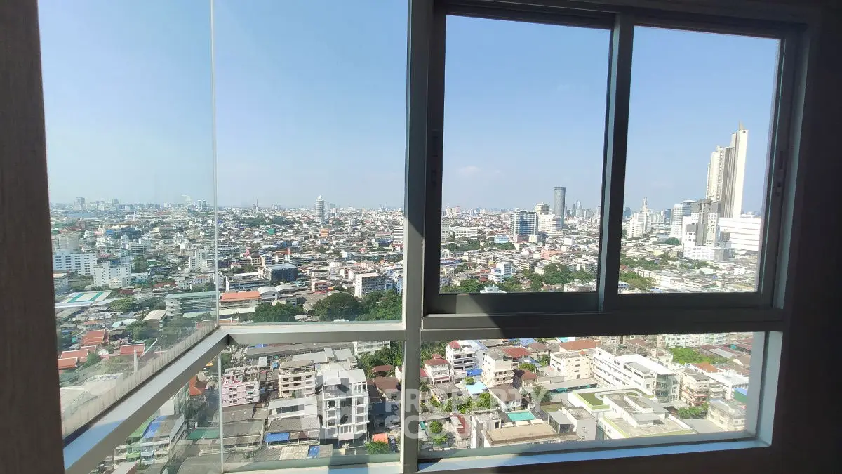 Stunning cityscape view from high-rise apartment window, showcasing urban skyline.