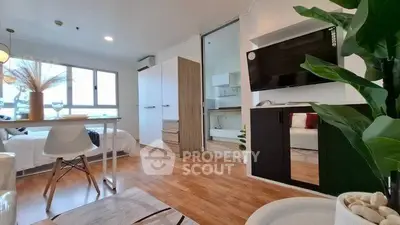 Modern open-plan living room with wooden flooring and stylish decor