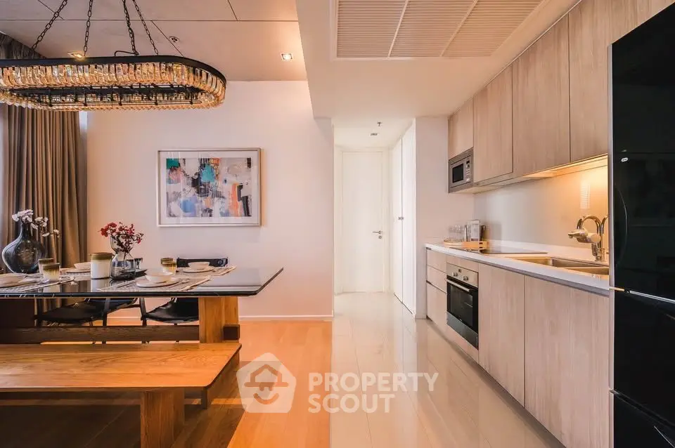 Modern kitchen and dining area with elegant lighting and contemporary decor.