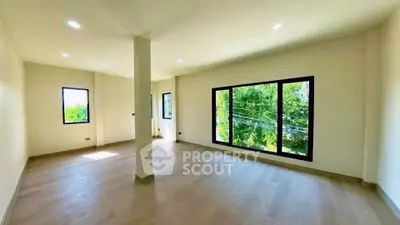Spacious and bright living room with large windows and natural light