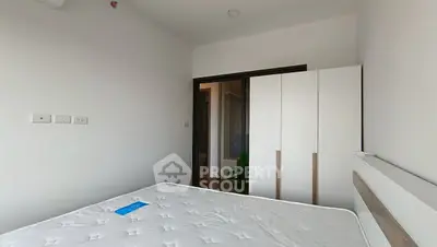 Minimalist bedroom with white wardrobe and bed in modern apartment