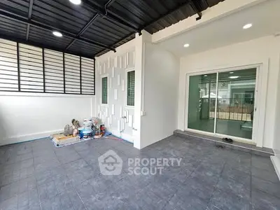 Spacious modern patio with sleek tile flooring and sliding glass doors