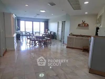 Spacious open-plan living and dining area with natural light and modern furnishings.