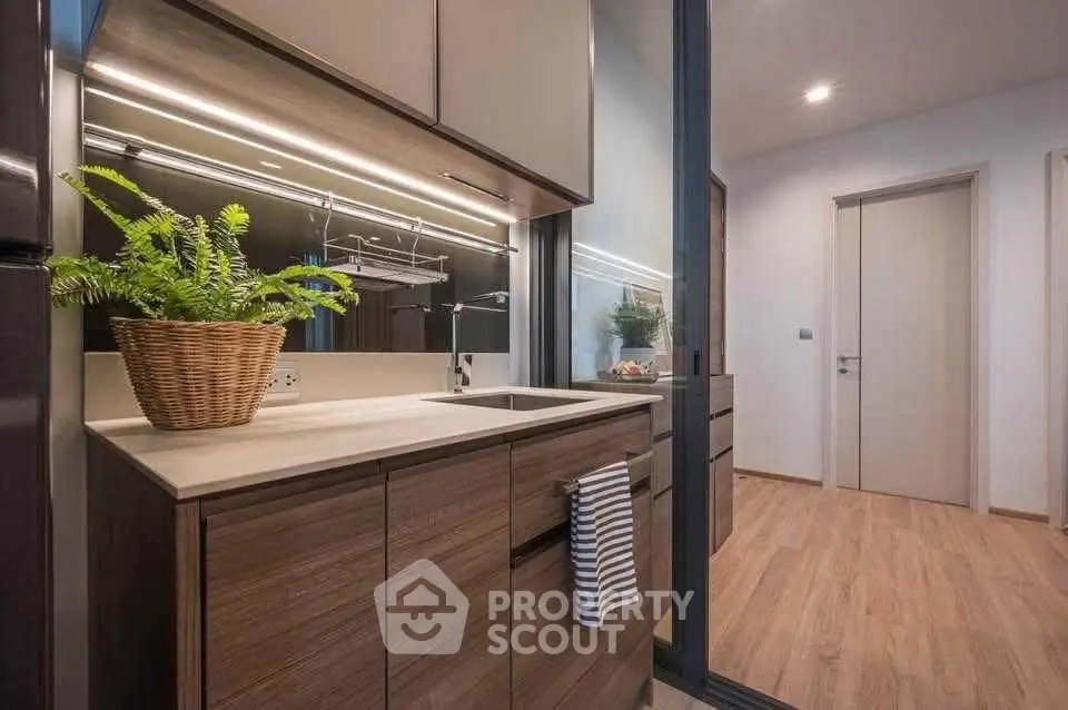 Modern kitchen with sleek cabinetry and stylish lighting