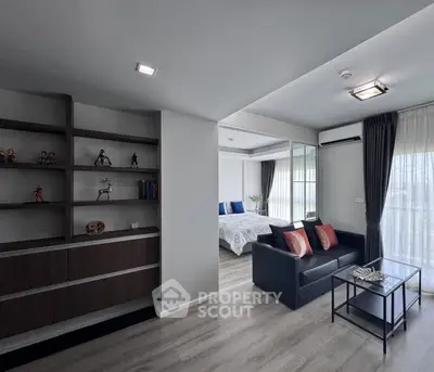 Modern living room with sleek design and cozy bedroom view