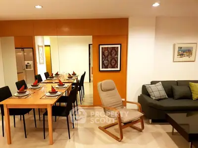 Modern living room with dining area, stylish furniture, and elegant decor in a cozy apartment.