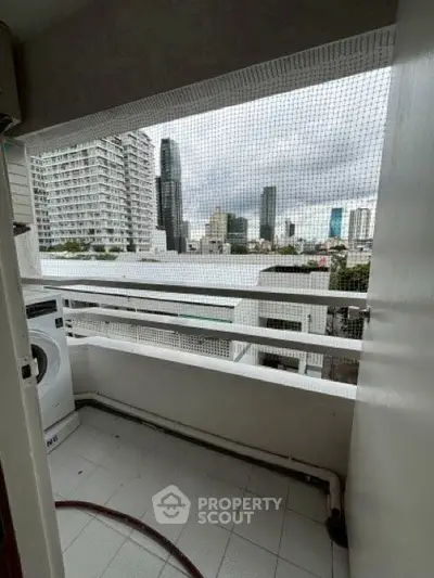 Urban balcony with city view and washing machine, perfect for modern living.