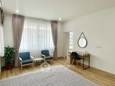 Spacious bedroom with modern decor and natural light