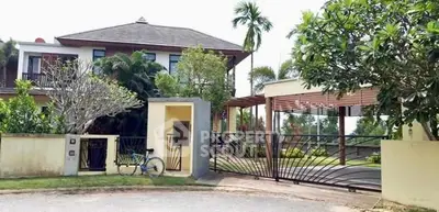 Stunning modern villa with lush garden and secure gated entrance, perfect for luxurious living.