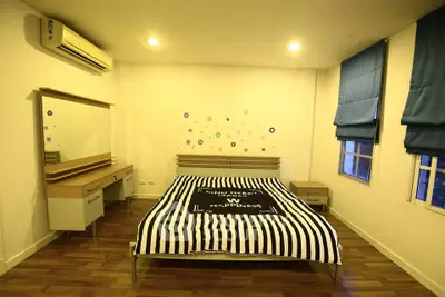 Cozy bedroom with modern decor and ample natural light