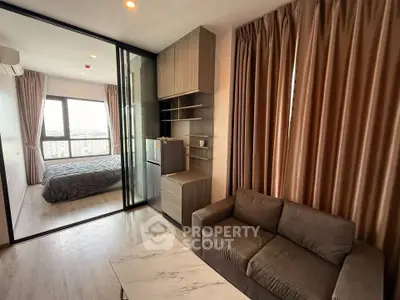 Modern apartment interior with cozy living room and bedroom, featuring large windows and elegant curtains.