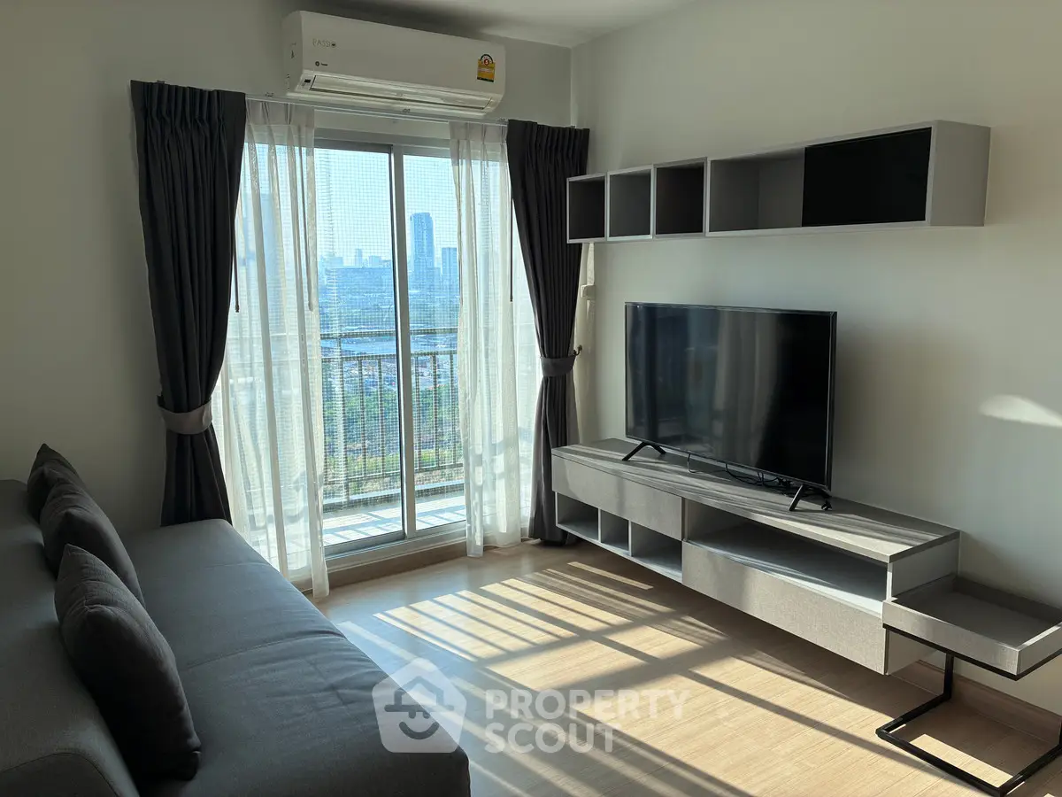 Modern living room with city view, featuring sleek furniture and natural light.