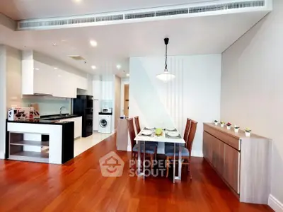 Spacious modern dining area with open kitchen and wooden flooring