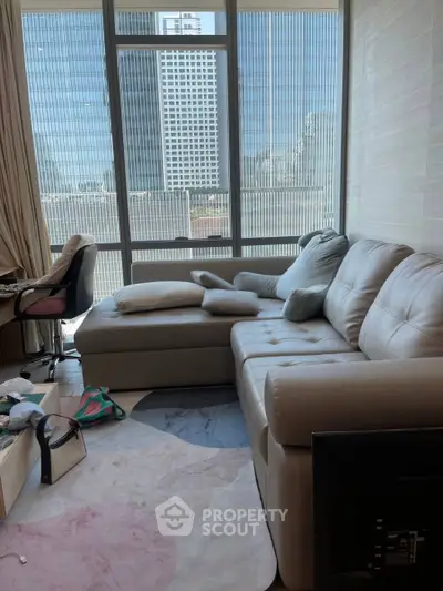 Modern living room with large windows and stylish furniture in urban apartment