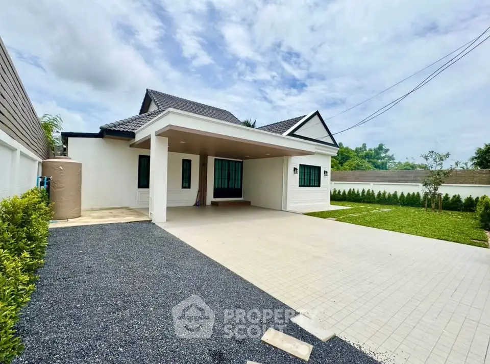 Charming single-story home with spacious driveway and lush green garden