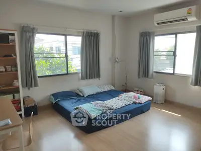 Spacious bedroom with natural light and minimalist decor