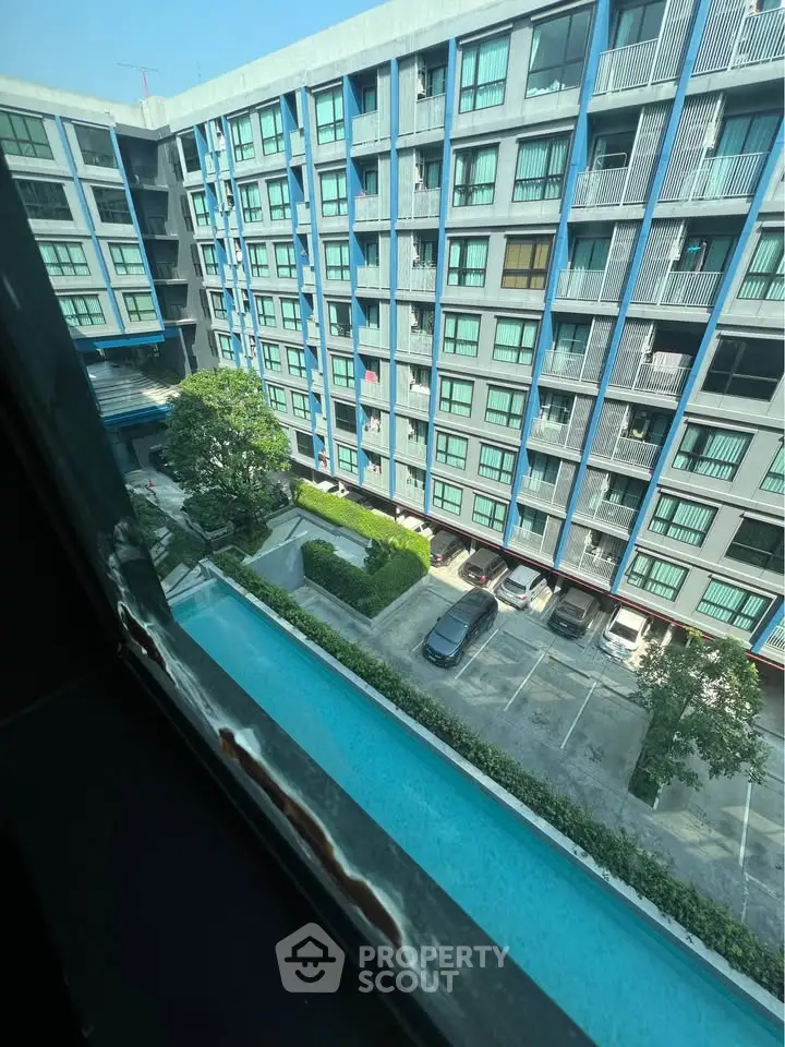 Modern apartment building with pool and parking view from window