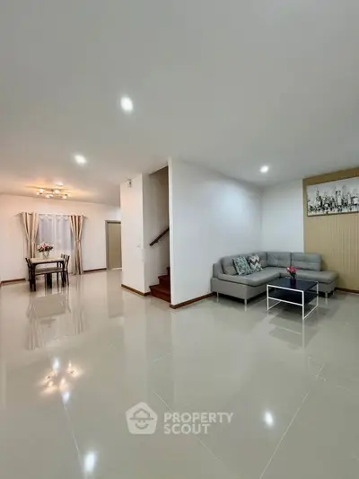 Spacious modern living room with sleek tile flooring and cozy corner sofa