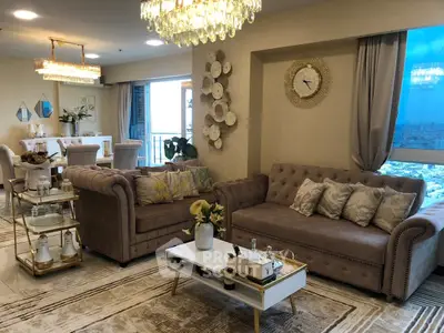 Luxurious living room with elegant decor and stunning city view, featuring plush sofas and chic lighting.