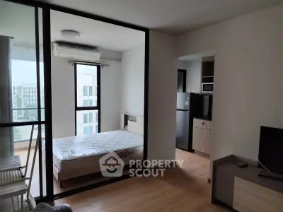Modern apartment interior with bedroom, kitchen, and balcony view