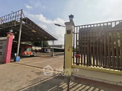 Spacious industrial property with large open area and secure fencing, ideal for business operations.