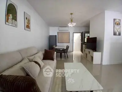Spacious modern living room with elegant decor and comfortable seating in a stylish apartment.