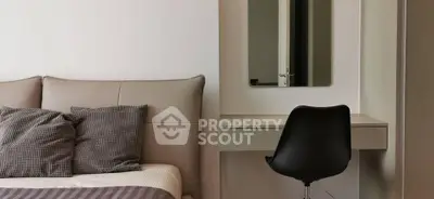 Modern bedroom with stylish chair and sleek vanity mirror