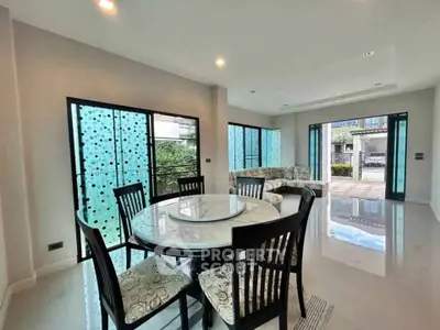 Spacious modern living room with elegant dining area and large windows