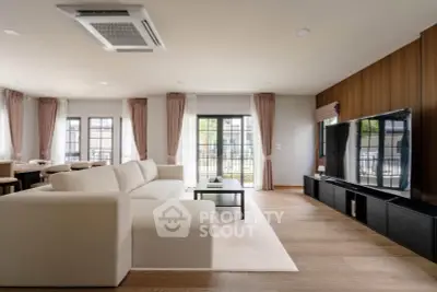 Spacious modern living room with large windows and elegant decor