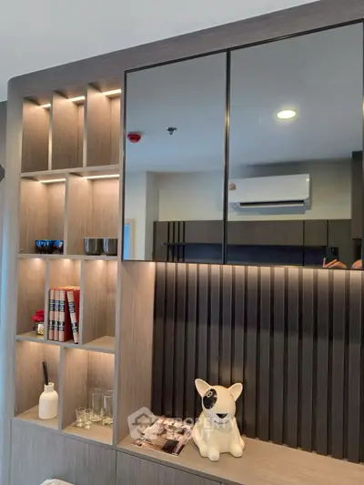 Modern living room with stylish shelving and decorative accents, featuring a unique dog figurine and ambient lighting.