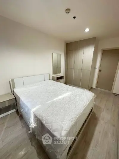 Spacious modern bedroom with sleek furniture and ample storage space