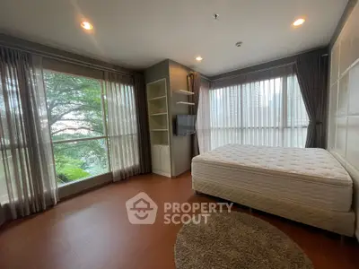 Spacious bedroom with large windows and scenic view in modern apartment