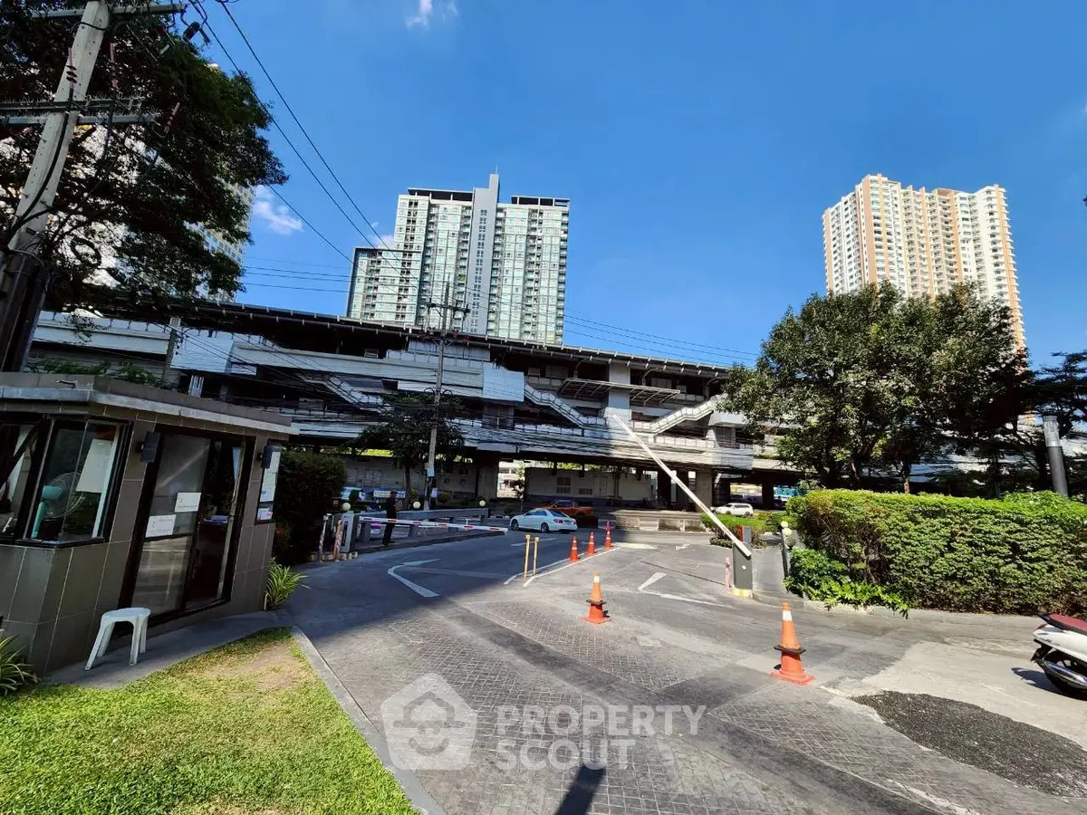 Modern urban residential buildings with lush greenery and secure entrance