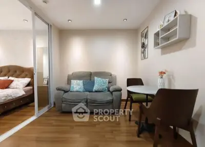 Cozy living room with modern decor and adjacent bedroom view